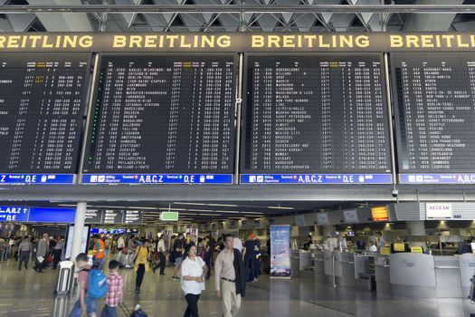 FRANKFURT AM MAIN, GERMANY - JULY 2, 2015: Travelers at public area at international Frankfurt Airport, the busiest airport in Germany. Longer exposure.

Frankfurt am Main, Germany - July 2, 2015: Travelers at public area at international Frankfurt Airport, the busiest airport in Germany. In 2012, Frankfurt handled 57.5 million passengers. Longer exposure.