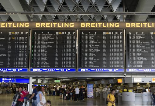 FRANKFURT AM MAIN, GERMANY - JULY 2, 2015: Travelers at public area at international Frankfurt Airport, the busiest airport in Germany. Longer exposure.

Frankfurt am Main, Germany - July 2, 2015: Travelers at public area at international Frankfurt Airport, the busiest airport in Germany. In 2012, Frankfurt handled 57.5 million passengers. Longer exposure.