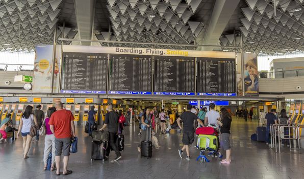 FRANKFURT AM MAIN, GERMANY - JULY 2, 2015: Travelers at public area at international Frankfurt Airport, the busiest airport in Germany. Longer exposure.

Frankfurt am Main, Germany - July 2, 2015: Travelers at public area at international Frankfurt Airport, the busiest airport in Germany. In 2012, Frankfurt handled 57.5 million passengers. Longer exposure.