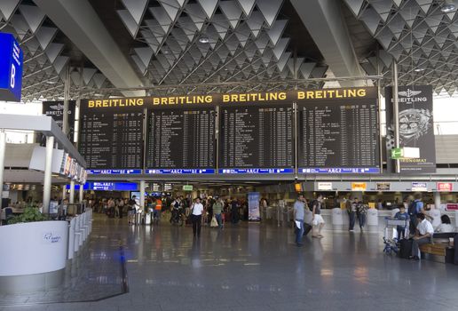 FRANKFURT AM MAIN, GERMANY - JULY 2, 2015: Travelers at public area at international Frankfurt Airport, the busiest airport in Germany. Longer exposure.

Frankfurt am Main, Germany - July 2, 2015: Travelers at public area at international Frankfurt Airport, the busiest airport in Germany. In 2012, Frankfurt handled 57.5 million passengers. Longer exposure.