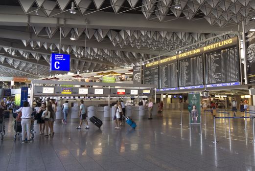 FRANKFURT AM MAIN, GERMANY - JULY 2, 2015: Travelers at public area at international Frankfurt Airport, the busiest airport in Germany. Longer exposure.

Frankfurt am Main, Germany - July 2, 2015: Travelers at public area at international Frankfurt Airport, the busiest airport in Germany. In 2012, Frankfurt handled 57.5 million passengers. Longer exposure.