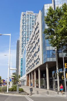 BARCELONA, SPAIN - JULY 4, 2015: Modern architecture of one urban district in Barcelona, Spain.

Barcelona, Spain - July 4, 2015: Modern architecture of one urban district in Barcelona, Spain. People are walking by street.