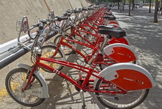 BARCELONA, SPAIN - JULY 4, 2015: Public Service Vehicles bicycles Vodafone Bicing. Bicing is the name of a bicycle sharing system in Barcelona inaugurated on March 22, 2007.

Barcelona, Spain - July 4, 2015: Public Service Vehicles bicycles Vodafone Bicing. Bicing is the name of a bicycle sharing system in Barcelona inaugurated on March 22, 2007.