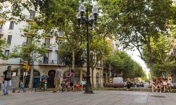 BARCELONA, SPAIN - JULY 5, 2015: Crowded La Rambla street at the heart of Barcelona, Spain.

Barcelona, Spain - July 5, 2015: Crowded La Rambla street at the heart of Barcelona, Spain. People are walking by street.