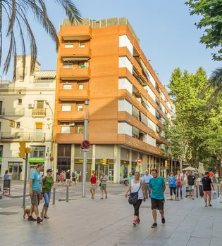 BARCELONA, SPAIN - JULY 5, 2015: Crowded La Rambla street at the heart of Barcelona, Spain.

Barcelona, Spain - July 5, 2015: Crowded La Rambla street at the heart of Barcelona, Spain. People are walking by street.