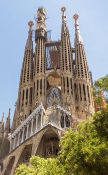 BARCELONA, SPAIN - JULY 6, 2015: La Sagrada Familia - the impressive cathedral designed by Gaudi, which is being build since 19 March 1882 and is not finished yet.

Barcelona, Spain - July 6, 2015: La Sagrada Familia - the impressive cathedral designed by Gaudi, which is being build since 19 March 1882 and is not finished yet.