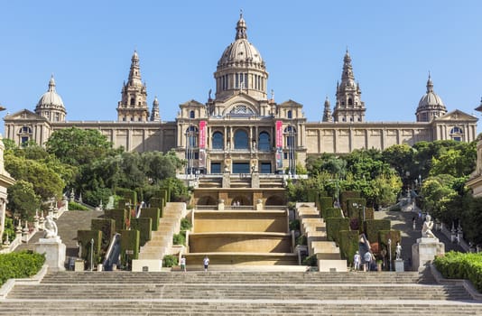 BARCELONA, SPAIN - JULY 6, 2015: Catalan National Museum of Art in Barcelona, Spain.

Barcelona, Spain - July 6, 2015: Catalan National Museum of Art in Barcelona, Spain. Built following the Barcelona International Exposition of 1929, held in the mountain of Montjuic. Today is the National Museum of Catalan Art (MNAC). People are walking near museum.
