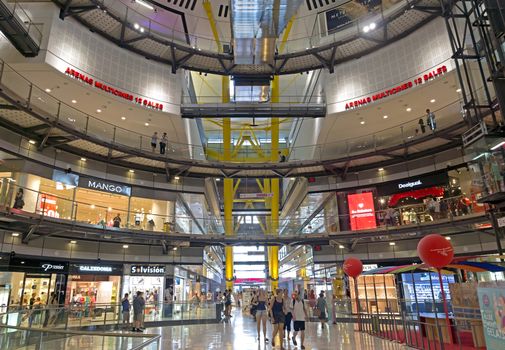 BARCELONA, SPAIN - JULY 8, 2015: Interior of the Las Arenas shopping centre, former bullring of Las Arenas in Barcelona, Spain. Built within an old bullring structure on Placa Espanya, opened on March 25, 2011.

Barcelona, Spain - July 8, 2015: Interior of the Las Arenas shopping centre, former bullring of Las Arenas in Barcelona, Spain. Built within an old bullring structure on Placa Espanya, opened on March 25, 2011. People are shopping.