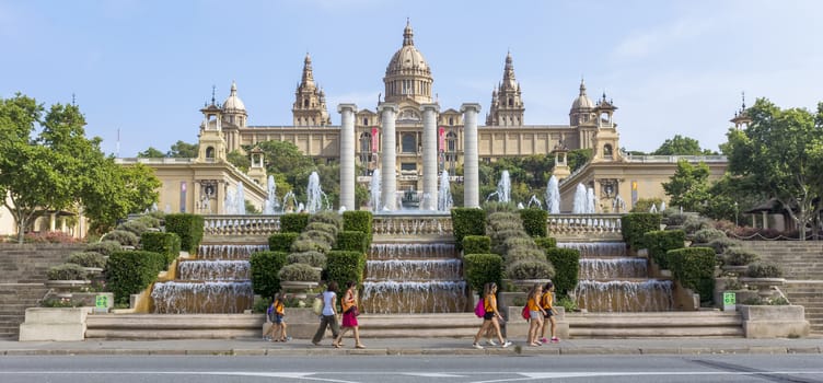 BARCELONA, SPAIN - JULY 8, 2015: Catalan National Museum of Art in Barcelona, Spain.

Barcelona, Spain - July 8, 2015: Catalan National Museum of Art in Barcelona, Spain. Built following the Barcelona International Exposition of 1929, held in the mountain of Montjuic. Today is the National Museum of Catalan Art (MNAC). People are walking by square.
