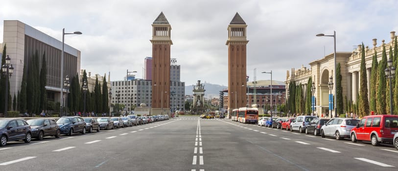 BARCELONA, SPAIN - JULY 8, 2015: Two Venetian towers located at Placa d'Espanya in Barcelona. The most beautiful square in the Catalan capital.

Barcelona, Spain - July 8, 2015: Two Venetian towers located at Placa d'Espanya in Barcelona. The most beautiful square in the Catalan capital. People are walking by street.