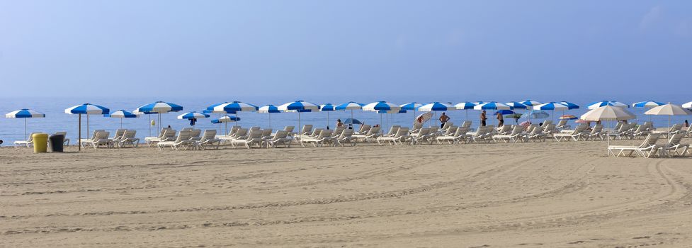 BARCELONA, SPAIN - JULY 12, 2015: La Barceloneta Beach in Barcelona, Spain. This popular beach hosts about 500000 visitors from everywhere during the summer season.

Barcelona, Spain - July 12, 2015: La Barceloneta Beach in Barcelona, Spain. This popular beach hosts about 500000 visitors from everywhere during the summer season. People are resting at the beach.