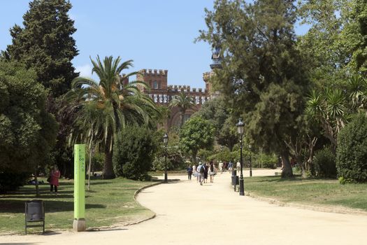 BARCELONA, SPAIN - JULY 12, 2015: Parc de la Ciutadella, one of the largest green areas in the center of Barcelona.

Barcelona, Spain - July 12, 2015: Parc de la Ciutadella, one of the largest green areas in the center of Barcelona. People are walking by parkway.