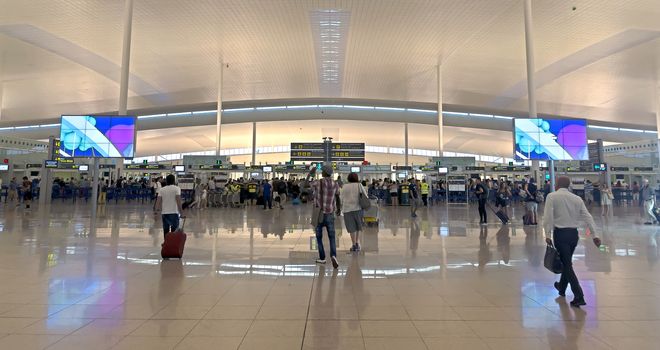BARCELONA, SPAIN - JULY 16, 2015: The public check-in area of Terminal T1 of El Prat-Barcelona airport.

Barcelona, Spain - July 16, 2015: The public check-in area of Terminal T1 of El Prat-Barcelona airport. This airport was inaugurated in 1963. Airport is one of the biggest in Europe and one of the busiest in the world. People are walking to check-in.