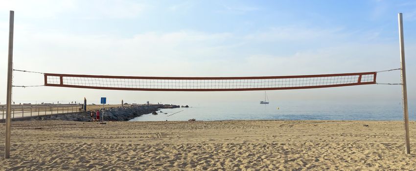 A volleyball net on the beach early in the morning