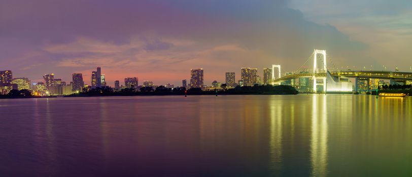 Tokyo, Japan - September 27, 2019: Panorama at sunset of the city skyline and the Rainbow Bridge, in Tokyo, Japan