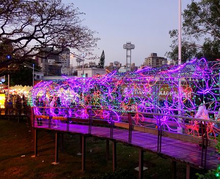 KAOHSIUNG, TAIWAN -- FEBRUARY 13, 2016: A wooden walkway is illuminated with colorful lights during the 2016 Lantern Festival.