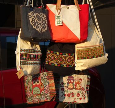 KAOHSIUNG, TAIWAN -- DECEMBER 14, 2019: A street vendor sells handbags with local indigenous tribal designs.