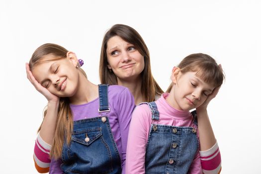 Mom holds the heads of children on the palms, isolated on a white background