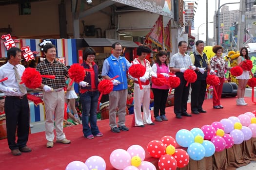 KAOHSIUNG, TAIWAN -- NOVEMBER 20, 2015: Local politicians and businessmen perform the ribbon cutting ceremony at the opening of the Jiangguo Outdoor Market.
