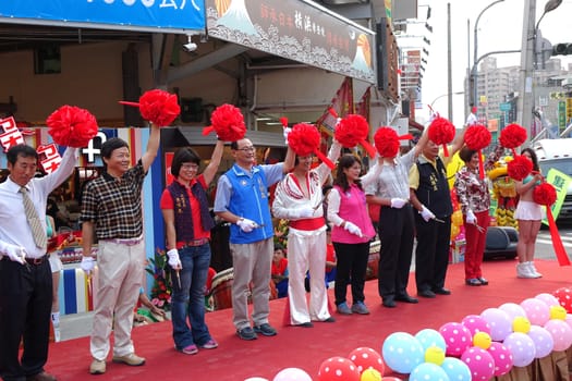 KAOHSIUNG, TAIWAN -- NOVEMBER 20, 2015: Local politicians and businessmen perform the ribbon cutting ceremony at the opening of the Jiangguo Outdoor Market.