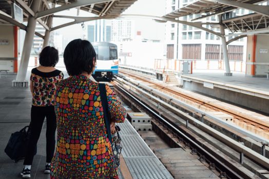 Skytrain train runs in Bangkok. Many people in Bangkok used skytrain to save time.