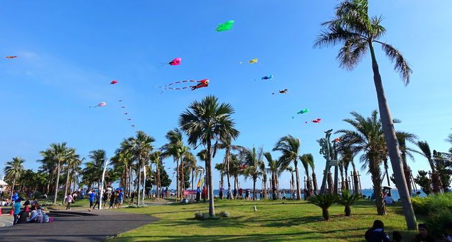 KAOHSIUNG, TAIWAN -- AUGUST 13 , 2017: Colorful kites are flying high as part of the yearly Black Sand Beach Festival on Cijin Island.