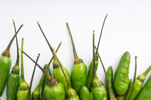 Green BirdÕs eye chili,Thai Chili pepper ,bird chili pepper nature isolate on white background. Selective focus and crop fragment