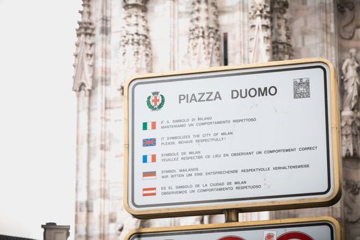 Milan, Italy - November 2, 2017: At the entrance to Duomo Square, a sign asks visitors to respect the place by observing the correct behavior