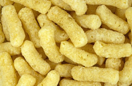 Air corn sticks with powdered sugar as a background.