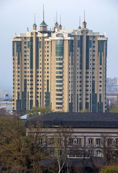 ALMATY, KAZAKHSTAN - OCTOBER 16, 2015: Multi-storey residential complex "Capital Center" is located in the historic city of Almaty. The complex is composed of three 23-storey buildings.

Almaty, Kazakhstan - October 16, 2015: View of Almaty city. Multi-storey residential complex "Capital Center" is located in the historic city of Almaty. The complex is composed of three 23-storey buildings.
