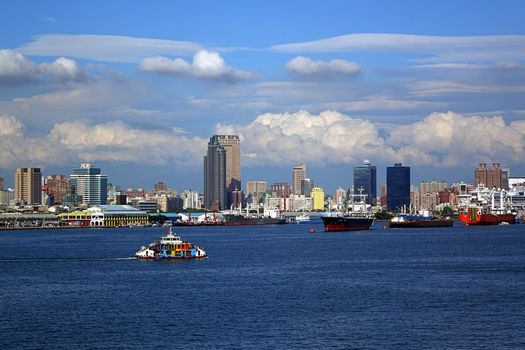 KAOHSIUNG, TAIWAN -- MAY 11, 2014: A panoramic view of Kaohsiung city and port with the cross-harbor ferry in the foreground