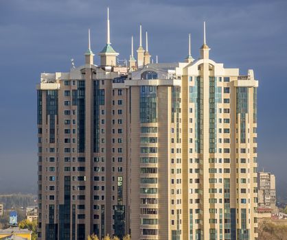 ALMATY, KAZAKHSTAN - OCTOBER 17, 2015: Multi-storey residential complex "Capital Center" is located in the historic city of Almaty. The complex is composed of three 23-storey buildings.

Almaty, Kazakhstan - October 17, 2015: View of Almaty city. Multi-storey residential complex "Capital Center" is located in the historic city of Almaty. The complex is composed of three 23-storey buildings.