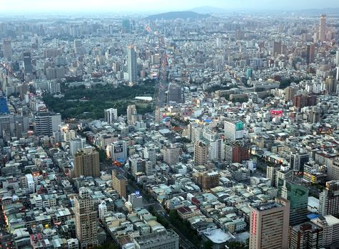 KAOHSIUNG, TAIWAN -- JULY 13, 2014: This aerial view of Kaohsiung City at evening time shows the downtown area and the central park.
