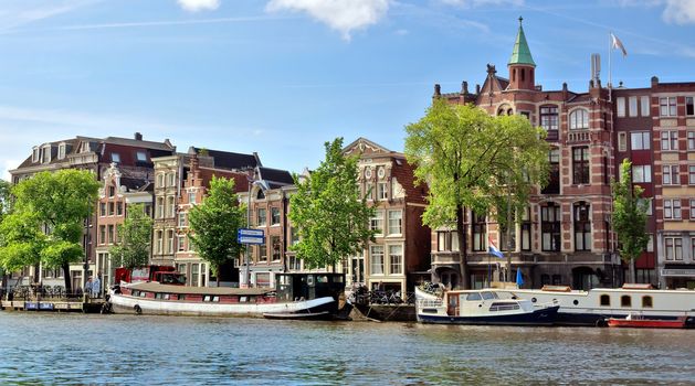 AMSTERDAM, NETHERLANDS - MAY 30: Amsterdam canals on May 30, 2014 in Amsterdam, Netherlands. View of Amsterdam canals and typical dutch houses.

Amsterdam, Netherlands - May 30, 2014: View of Amsterdam canals and typical dutch houses.