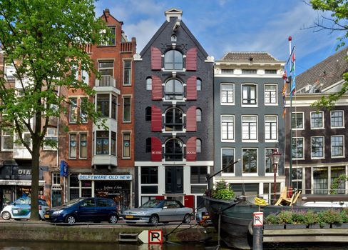 AMSTERDAM, NETHERLANDS - MAY 30: Amsterdam canals on May 30, 2014 in Amsterdam, Netherlands. View of Amsterdam canals and typical dutch houses.

Amsterdam, Netherlands - May 30, 2014: View of Amsterdam canals and typical dutch houses.