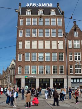 AMSTERDAM, NETHERLANDS - MAY 30: View of Amsterdam city and typical dutch houses on May 30, 2014 in Amsterdam, Netherlands.

Amsterdam, Netherlands - May 30, 2014: View of Amsterdam city and typical dutch houses. People are walking by street.
