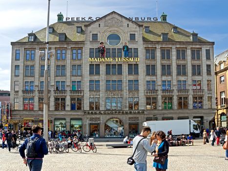 AMSTERDAM, NETHERLANDS - MAY 30: Madame Tussauds wax museum on May 30, 2014 in Amsterdam, Netherlands. It is a major tourist attraction in Amsterdam, displaying waxworks of famous figures.

Amsterdam, Netherlands - May 30, 2014: Madame Tussauds wax museum. It is a major tourist attraction in Amsterdam, displaying waxworks of famous figures. People are walking and standing on the square.