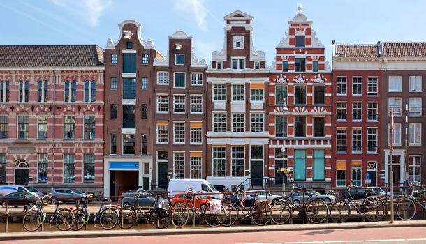 AMSTERDAM, NETHERLANDS - MAY 30: View of Amsterdam city and typical dutch houses on May 30, 2014 in Amsterdam, Netherlands.

Amsterdam, Netherlands - May 30, 2014: View of Amsterdam city and typical dutch houses.