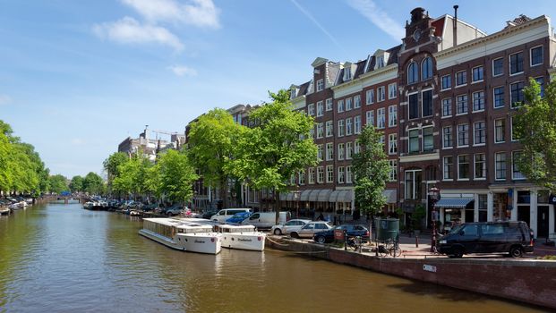 AMSTERDAM, NETHERLANDS - MAY 30: Amsterdam canals on May 30, 2014 in Amsterdam, Netherlands. View of Amsterdam canals and typical dutch houses.

Amsterdam, Netherlands - May 30, 2014: View of Amsterdam canals and typical dutch houses.