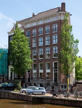 AMSTERDAM, NETHERLANDS - MAY 30: Amsterdam canals on May 30, 2014 in Amsterdam, Netherlands. View of Amsterdam canals and typical dutch houses.

Amsterdam, Netherlands - May 30, 2014: View of Amsterdam canals and typical dutch houses.