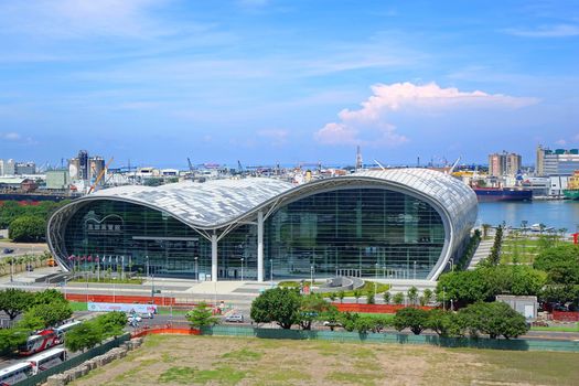 KAOHSIUNG, TAIWAN -- JUNE 11, 2015: The new Kaohsiung Exhibition Center with its characteristic waved roof. In the background you can see the large port.

