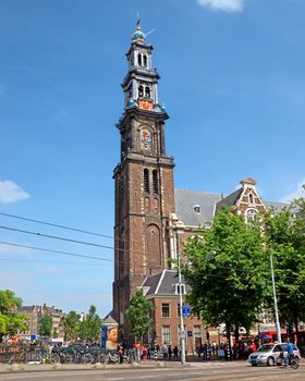AMSTERDAM, NETHERLANDS - MAY 30: Bell tower of the Westerkerk on May 30, 2014 in Amsterdam, Netherlands. Built in 1637 and designed by the famous Dutch architect Hendrick de Keyser.

Amsterdam, Netherlands - May 30, 2014: Bell tower of the Westerkerk in Amsterdam, the most important protestant church in the city of Amsterdam, Netherlands. Built in 1637 and designed by the famous Dutch architect Hendrick de Keyser. People are walking by street.