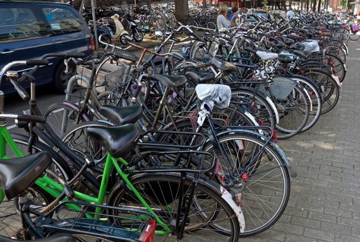 AMSTERDAM, NETHERLANDS - MAY 30: Amsterdam Central station. Many bicycles parked near of the Central station on May 30, 2014 in Amsterdam, Netherlands.

Amsterdam, Netherlands - May 30, 2014: Amsterdam Central station. Many bicycles parked near of the Central station.