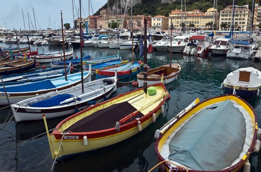 NICE, FRANCE - MAY 31, 2014: Colorful boats and buildings within a Port de Nice. Port de Nice was started in 1745.

Nice, France - May 31, 2014: Colorful buildings and boats within a Port de Nice in French Riviera. Port de Nice was started in 1745.