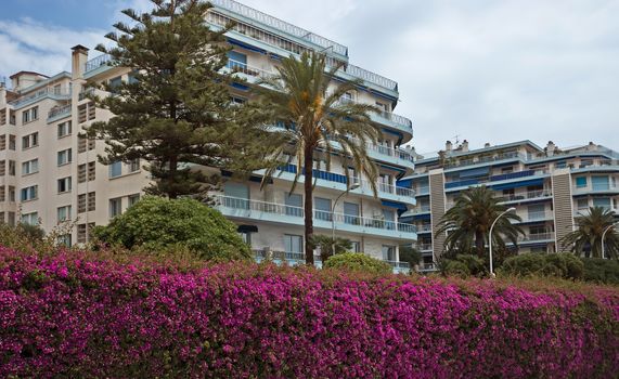 NICE, FRANCE - MAY 31, 2014: Architecture along Promenade des Anglais. Promenade des Anglais is a symbol of the Cote d'Azur and was built in 1830 at the expense of the British colony.

Nice, France - May 31, 2014: Architecture along Promenade des Anglais. Promenade des Anglais is a symbol of the Cote d'Azur and was built in 1830 at the expense of the British colony.