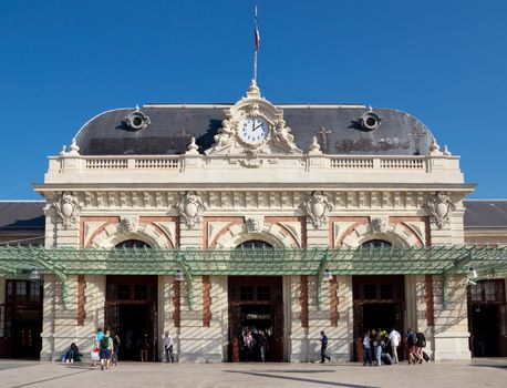NICE, FRANCE - JUNE 1, 2014: Gare de Nice - Ville is main railway station in Nice, completed in 1867 by architect Louis Bouchot and served by intercity and high speed TGV trains.

Nice, France - June 1, 2014: Gare de Nice - Ville is main railway station in Nice, completed in 1867 by architect Louis Bouchot and served by intercity and high speed TGV trains. Tourists coming and going from the station.