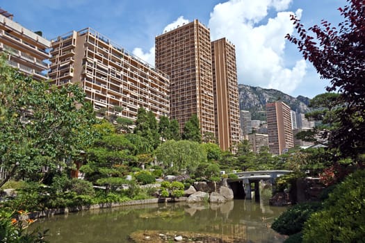 MONTE CARLO, MONACO - JUNE 1, 2014: View of Monte Carlo buildings from Japanese garden of Monaco.

Monte Carlo, Monaco - June 1, 2014: View of Monte Carlo buildings from Japanese garden of Monaco.