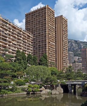MONTE CARLO, MONACO - JUNE 1, 2014: View of Monte Carlo buildings from Japanese garden of Monaco.

Monte Carlo, Monaco - June 1, 2014: View of Monte Carlo buildings from Japanese garden of Monaco.
