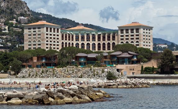MONTE CARLO, MONACO - JUNE 1, 2014: Architecture of residential buildings from the city beach.

Monte Carlo, Monaco - June 1, 2014: Architecture of residential buildings from the city beach. People are taking a sunbath.
