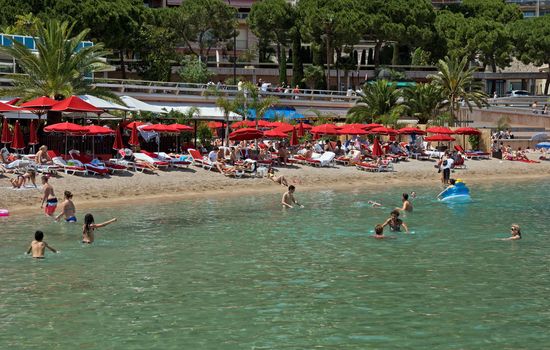 MONTE CARLO, MONACO - JUNE 1, 2014: City Beach of Monaco.

Monte Carlo, Monaco - June 1, 2014: ACity Beach of Monaco. People are taking a sunbath, sunbathing and swiming.